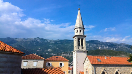 Obraz premium Famous chapel of the fortress and orange roofs in old city of Budva, Montenegro