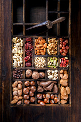 Nuts Mixed in a Wooden Vintage Box.Assortment, Walnuts,Pecan,Peanuts,Almonds,Hazelnuts,Macadamia,Cashews,Pistachios.Concept of Healthy Eating.Vegetarian.Copy space.selective focus.