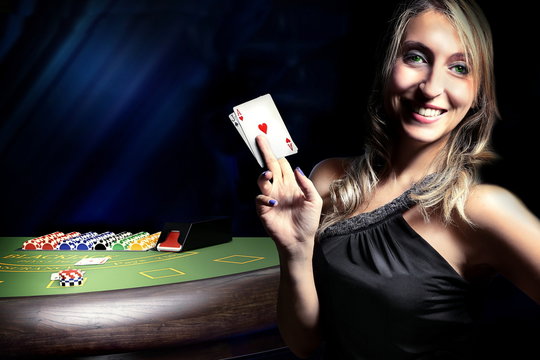 woman before dice throw on craps table at casino 