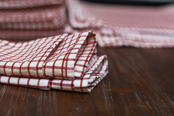 Checkered red and white napkin on wooden background