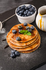 Stack of pancakes with fresh blueberry and caramel syrup