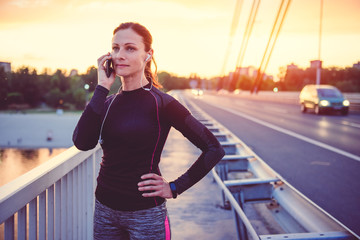 Fitness woman talking on smart phone