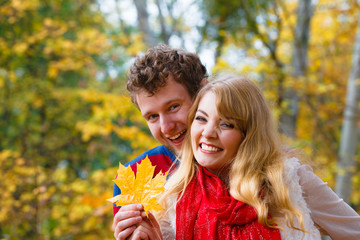 couple playing with leaf in autumn park