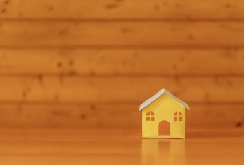 paper houses stands over a wooden background