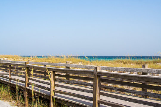 A boardwalk and view of the sea oats growing in the dunes of the Destin, Florida coast.
