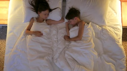 Children sleep in bed. View from above.