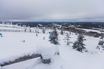 Fototapeta na wymiar Beautiful cold mountain view of ski resort, sunny winter day with slope, piste and ski lift 