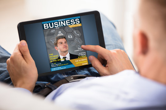 Businessman Looking At Business Magazine