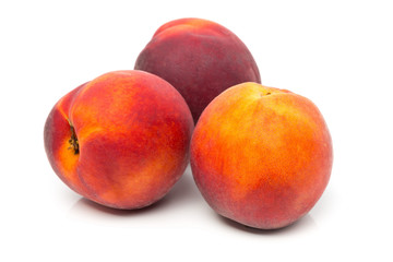 Three uncut, whole, ripe peaches fruit