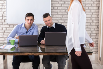 Businessmen Looking At Woman
