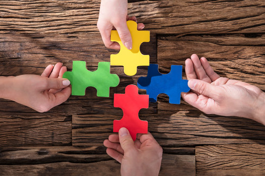 Hands Holding Jigsaw Puzzle