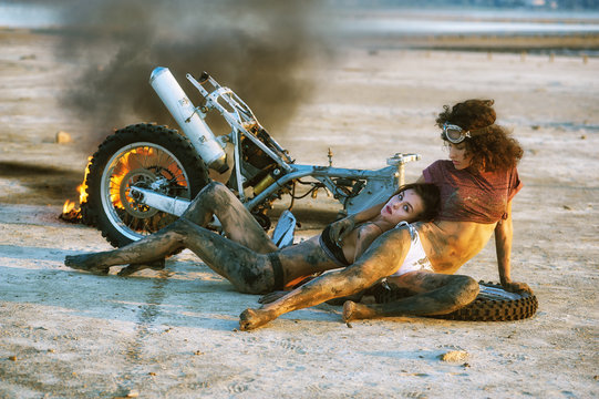 Beautiful sexy girl pose in front of a disassembled motorcycle
