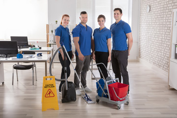 Janitors With Cleaning Equipments In The Office