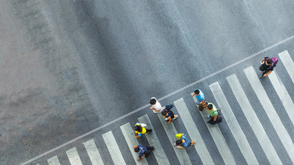 the busy city crowd move to pedestrian crosswalk on businees traffric road (Aerial photo, top view)