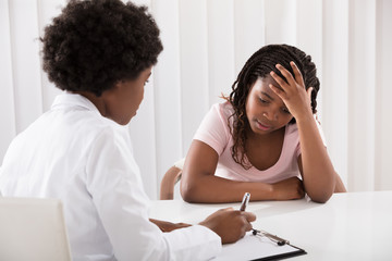 Female Doctor Comforting Depressed Patient