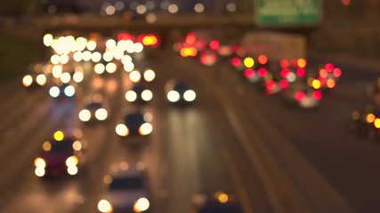 Defocused bokeh cars, SUVs, pickup trucks and semi-trailer trucks caught in traffic jam on busy multiple lane highway through Chicago city at night - Powered by Adobe