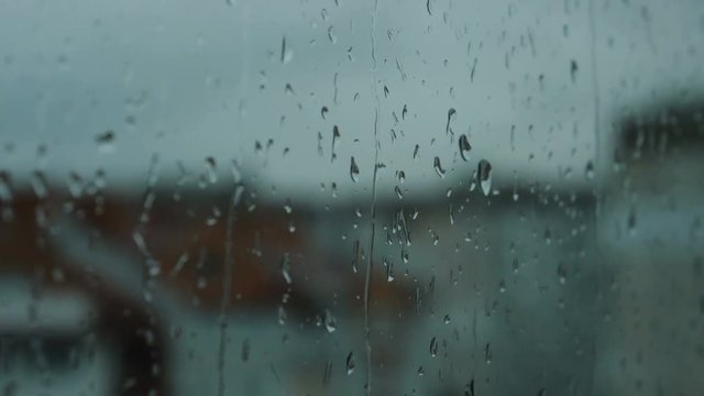 Close up image of rain drops falling on a window