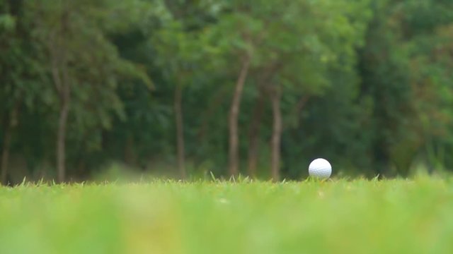 slow motion golfer hitting tee off golf ball 