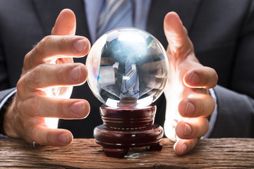 Midsection Of Businessman Covering Crystal Ball - obrazy, fototapety, plakaty