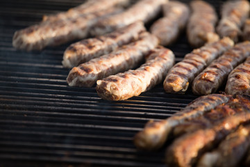 Sausages are fried on a barbecue