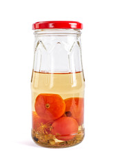 Glass jars of pickled salted red tomatoes cherry, tasty rustic canned isolated on white background.