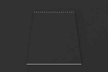 Blank black notebook with metal spiral bound on black background