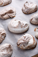 Homemade marble chocolate meringue cookies on a baking sheet