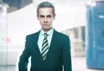 Fototapeta premium A handsome man in a jacket and tie for business negotiations. Looking at the camera. Office worker. Business decisions. Beautiful light background