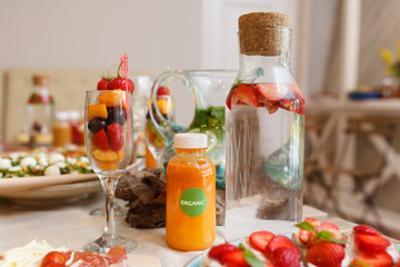 Food table with healthy delicious organic meal concept. People friends celebrate and eat healthy organic meals at served festive wooden table served for party.