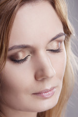 Girl with clean skin isolated on grey background closeup. Daytime makeup.