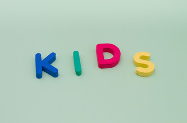 The word kids is from colored letters on a light green background