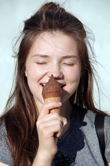 Smiling girl eats ice cream
