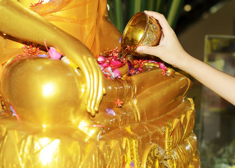 Songkran watering to Buddha statue for Songkran Festival Thailand