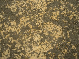 .The surface of a stone covered with sand, natural texture......