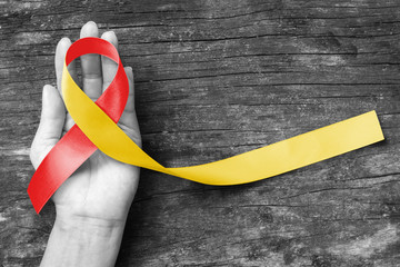 World hepatitis day and HIV/ HCV co-infection awareness with red yellow ribbon  (isolated  with...