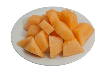 Fresh sweet cantaloupe on a plate, isolated on white background.