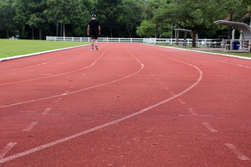 Fototapeta premium Close-up curve of a running track. Athletics track with its lane, white line and turn. Athletics lane around of football field.