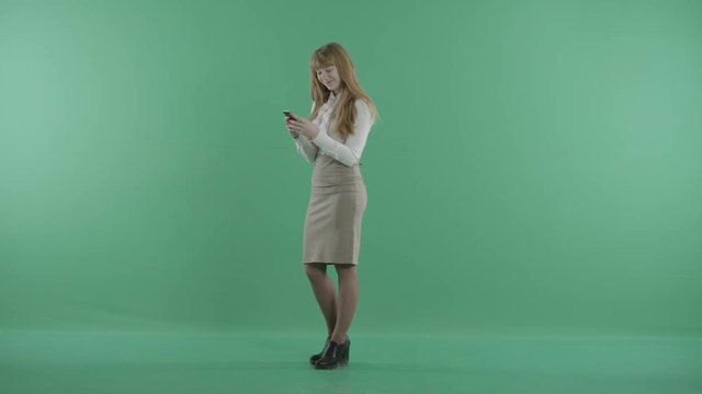 a nice girl is standing with the phone