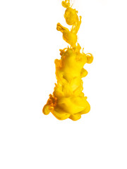 Ink swirl in water isolated on white background. The paint in the water. Soft dissemination a droplets of colored ink in water close-up. Abstract background. Explosion of splashes yellow acrylic ink.