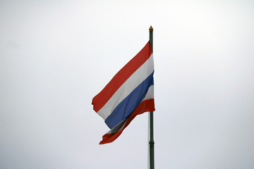 Thai National flag on the sky background. The flag of Thailand is striped in 3 colors: red, white and blue.