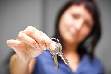 Realtor in empty apartment giving keys