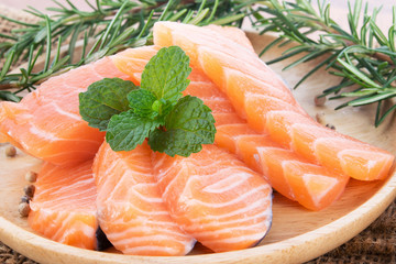 salmon with rosemary on wood background