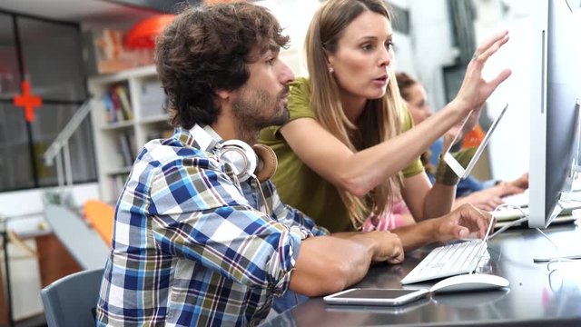 Start-up people working on desktop in co-working space