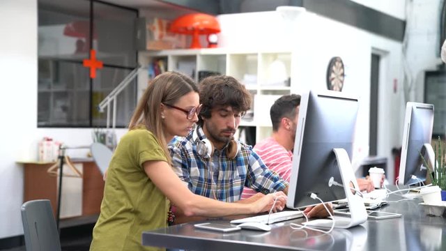 Start-up people working on desktop in co-working space