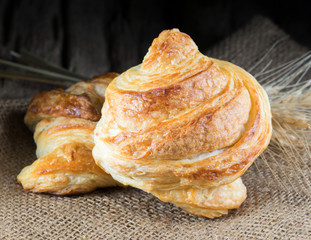 Tasty croissants on wooden background.