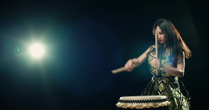 epic performance beautiful Asian girl drummer Taiko , makes the rhythm, Slow motion