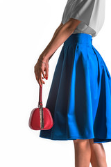 Girl holding a red bag in his hands. On a white background
