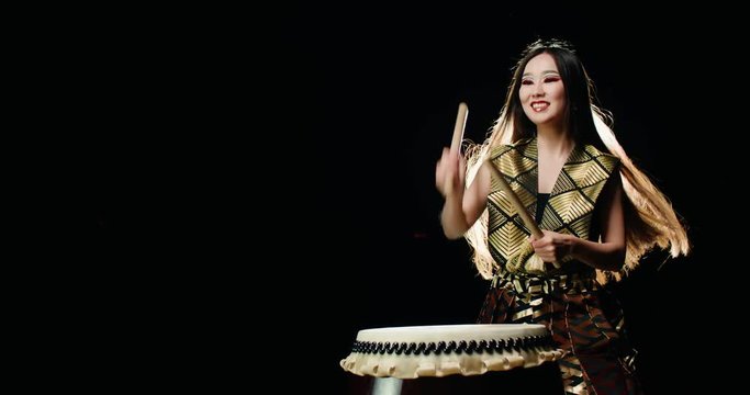 epic performance of Asian girl drumming Taiko , concert light, Slow motion