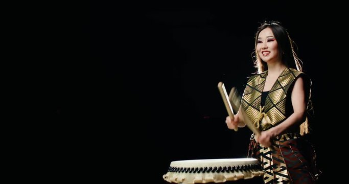 epic performance beautiful Asian girl drummer Taiko , makes the rhythm on the drum in Slow motion