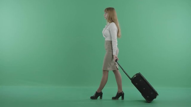 an attractive girl is looking around with a luggage in hands
